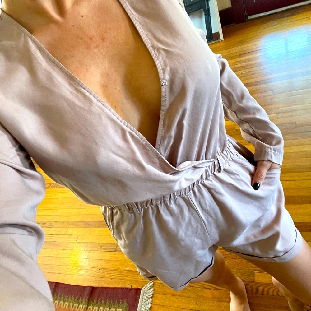Light blush color . Button came off in front. Romper has pockets. Never worn